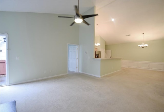 179 Camry Ln, Grayson, GA 30017 - unfurnished living room featuring a chandelier, light carpet, a ceiling fan, high vaulted ceiling, and a decorative wall