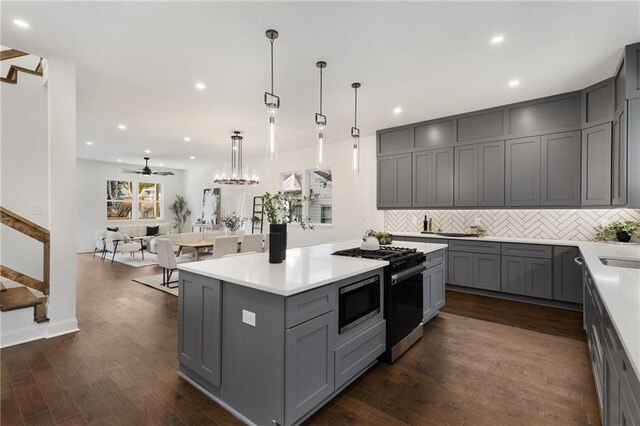 60 Newcastle St SW, Atlanta, GA 30314 - kitchen with gray cabinetry, stainless steel microwave, recessed lighting, decorative backsplash, and gas range