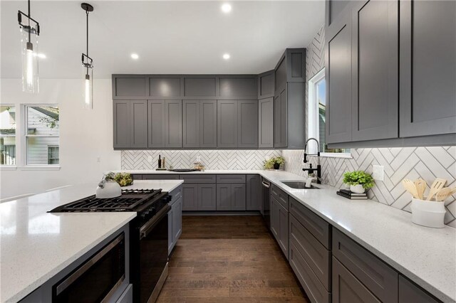 60 Newcastle St SW, Atlanta, GA 30314 - kitchen featuring appliances with stainless steel finishes, gray cabinets, decorative backsplash, light stone counters, and dark wood-style floors