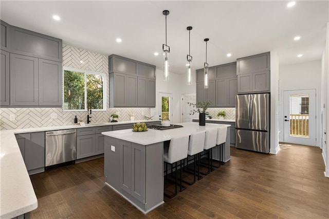 60 Newcastle St SW, Atlanta, GA 30314 - kitchen featuring appliances with stainless steel finishes, gray cabinets, decorative backsplash, a center island, and recessed lighting