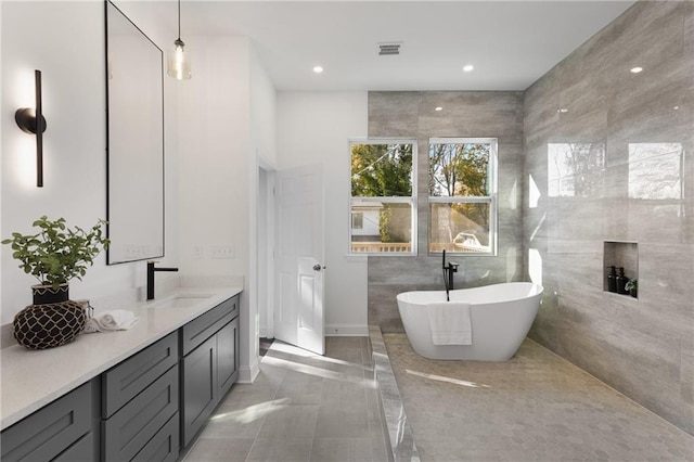 60 Newcastle St SW, Atlanta, GA 30314 - full bath featuring double vanity, a freestanding bath, recessed lighting, and tile patterned floors