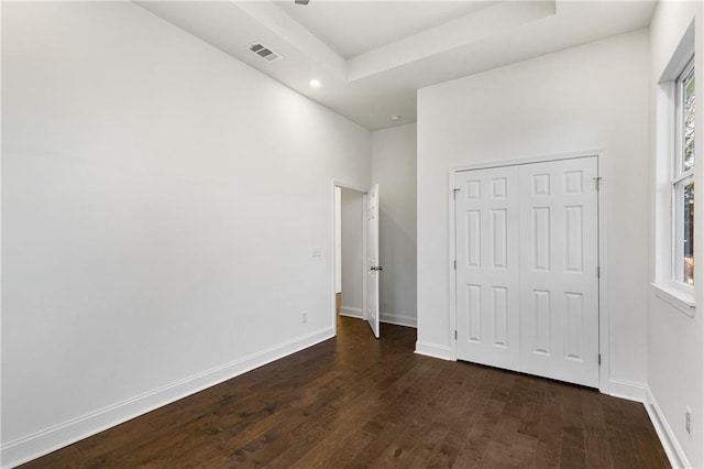 60 Newcastle St SW, Atlanta, GA 30314 - unfurnished bedroom with dark wood-type flooring, multiple windows, recessed lighting, a closet, and a raised ceiling