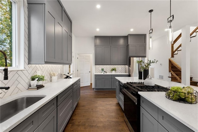 60 Newcastle St SW, Atlanta, GA 30314 - kitchen featuring gray cabinetry, gas stove, recessed lighting, freestanding refrigerator, and dark wood-style floors