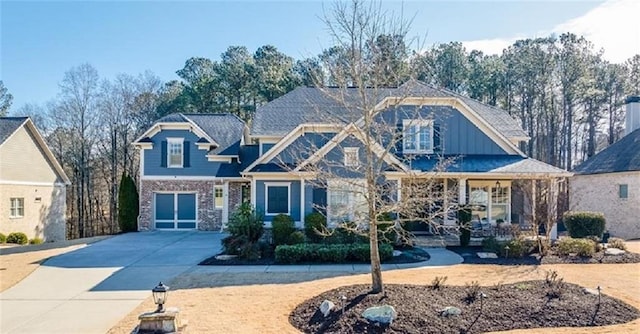 craftsman-style home featuring concrete driveway, brick siding, and board and batten siding
