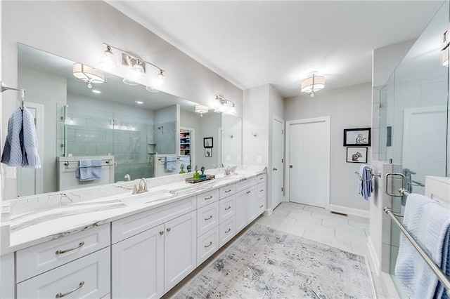 bathroom featuring a stall shower, double vanity, tile patterned flooring, and baseboards