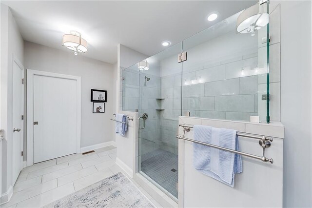 bathroom featuring a stall shower, baseboards, recessed lighting, and tile patterned flooring