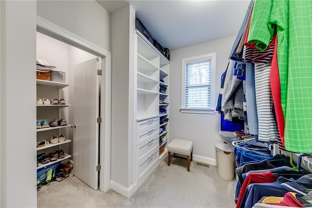 walk in closet with carpet floors