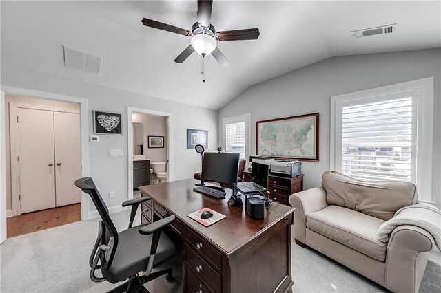 home office featuring vaulted ceiling, a ceiling fan, and baseboards