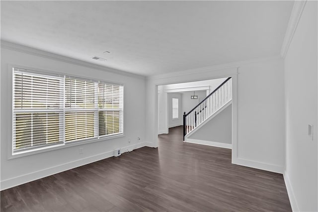 unfurnished living room with dark wood finished floors, baseboards, ornamental molding, and stairs