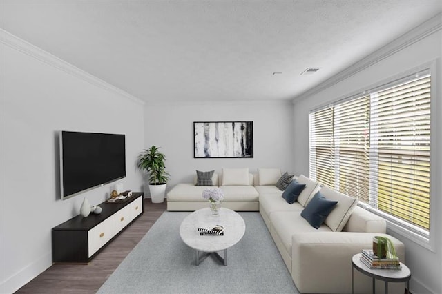 living room with plenty of natural light, wood finished floors, crown molding, and baseboards