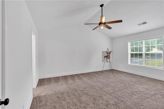 unfurnished room featuring lofted ceiling, a ceiling fan, carpet flooring, and baseboards
