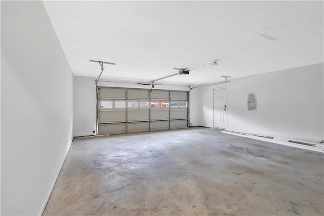 garage with a garage door opener and electric panel