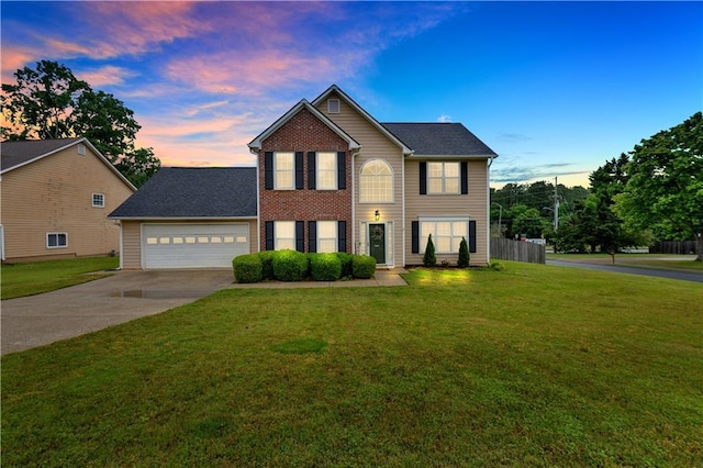 colonial home featuring concrete driveway and a garage