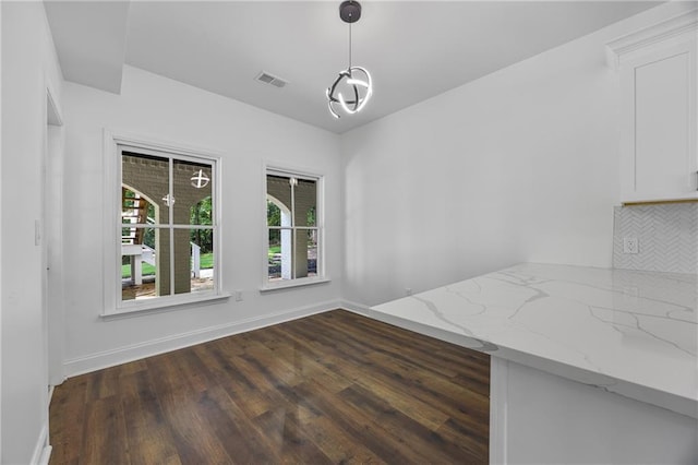 1217 Cabin Bridge Rd, Bethlehem, GA 30620 - unfurnished dining area featuring dark wood-style floors and baseboards