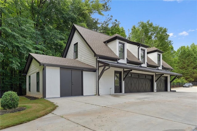1217 Cabin Bridge Rd, Bethlehem, GA 30620 - view of front facade with a garage, concrete driveway, and a shingled roof