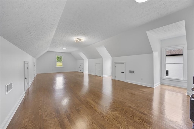 1217 Cabin Bridge Rd, Bethlehem, GA 30620 - bonus room with a textured ceiling, vaulted ceiling, baseboards, and wood finished floors