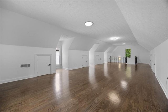 1217 Cabin Bridge Rd, Bethlehem, GA 30620 - additional living space featuring lofted ceiling, a textured ceiling, wood finished floors, and baseboards