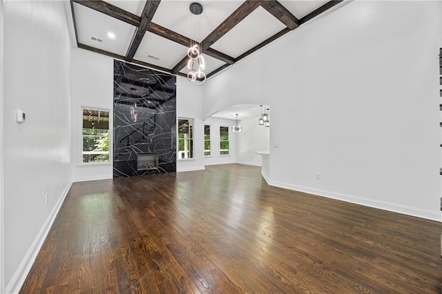 1217 Cabin Bridge Rd, Bethlehem, GA 30620 - unfurnished living room with a chandelier, coffered ceiling, healthy amount of natural light, arched walkways, and baseboards