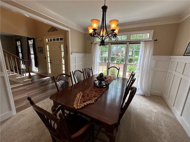 3962 Fox Glen Dr, Woodstock, GA 30189 - carpeted dining room with a decorative wall, stairway, a chandelier, crown molding, and a wainscoted wall