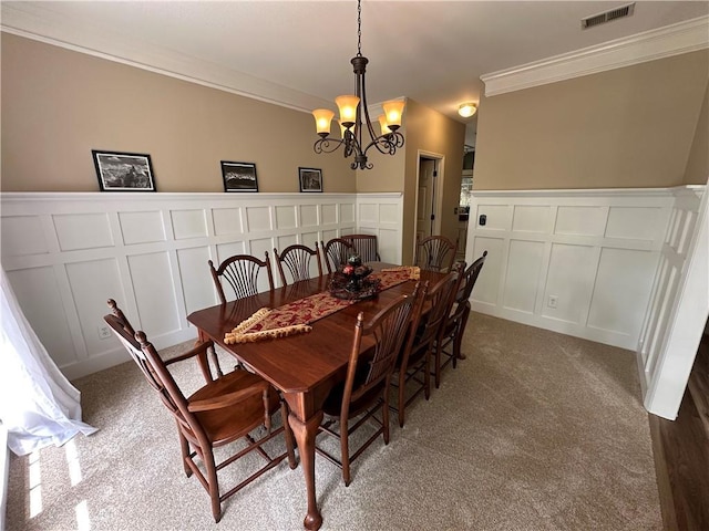 3962 Fox Glen Dr, Woodstock, GA 30189 - carpeted dining room featuring a decorative wall, ornamental molding, a chandelier, and a wainscoted wall