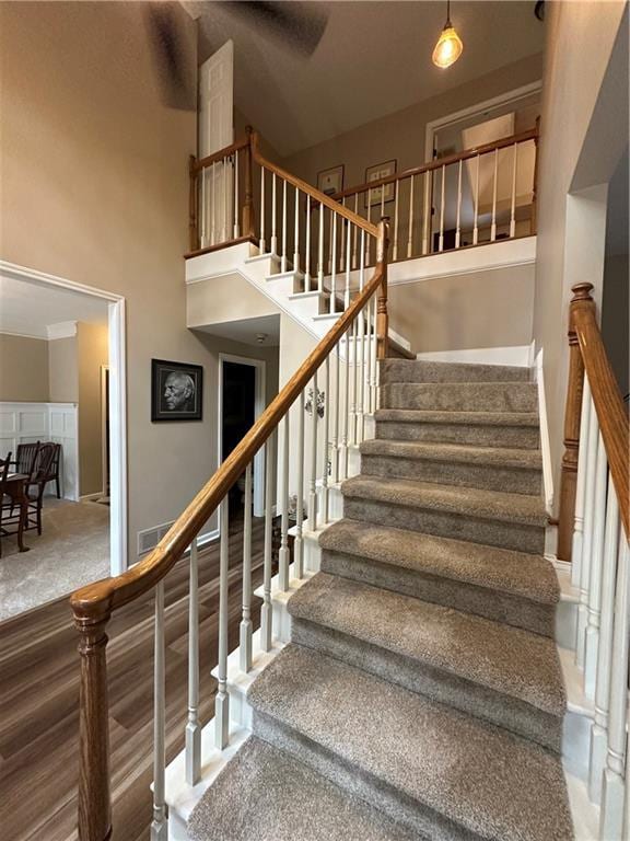 3962 Fox Glen Dr, Woodstock, GA 30189 - staircase with a high ceiling and carpet floors