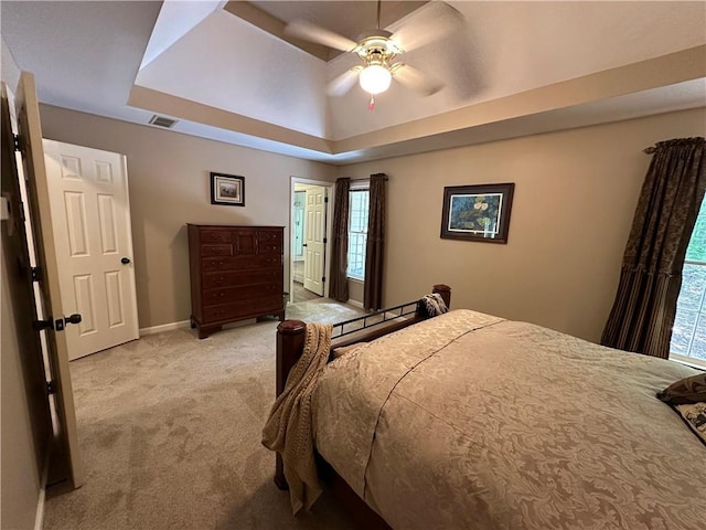 3962 Fox Glen Dr, Woodstock, GA 30189 - carpeted bedroom featuring multiple windows, a raised ceiling, and ceiling fan
