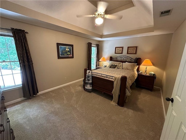 3962 Fox Glen Dr, Woodstock, GA 30189 - carpeted bedroom with a raised ceiling, multiple windows, and ceiling fan