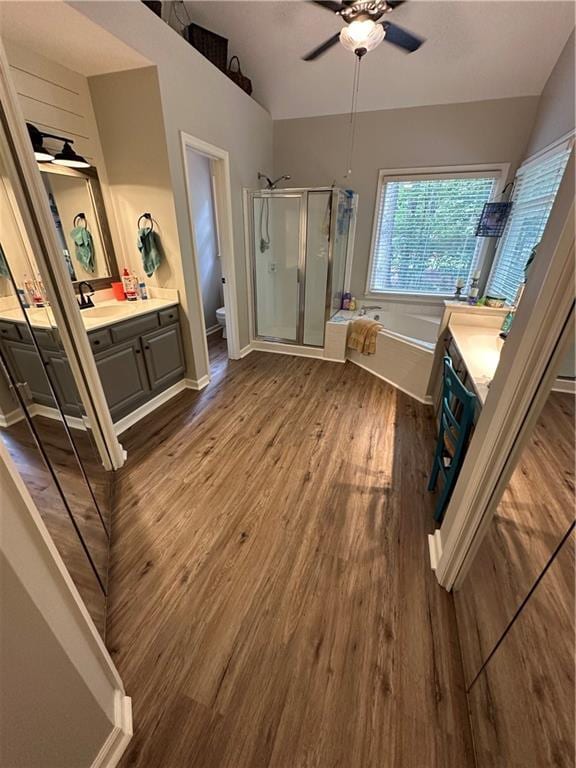 3962 Fox Glen Dr, Woodstock, GA 30189 - bathroom featuring vanity, ceiling fan, wood finished floors, a shower stall, and vaulted ceiling