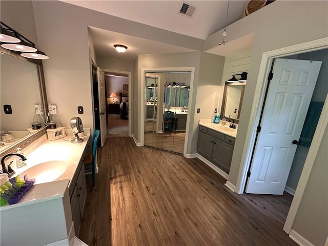 3962 Fox Glen Dr, Woodstock, GA 30189 - ensuite bathroom with wood finished floors, two vanities, and lofted ceiling