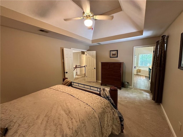 3962 Fox Glen Dr, Woodstock, GA 30189 - carpeted bedroom with a tray ceiling and ceiling fan