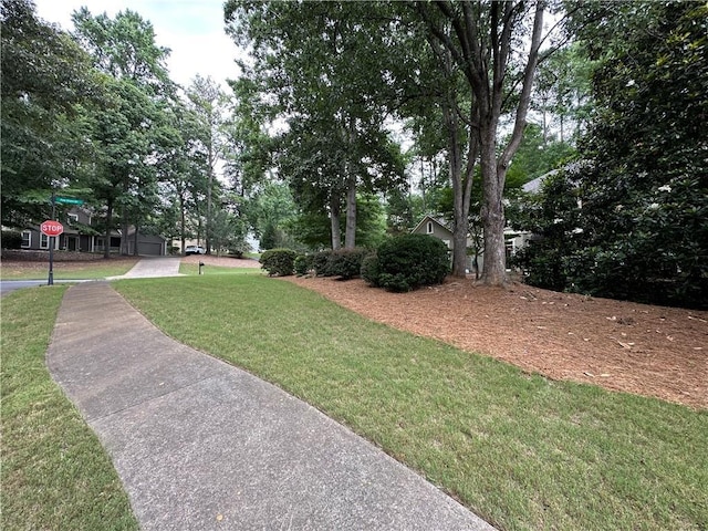 3962 Fox Glen Dr, Woodstock, GA 30189 - view of green lawn featuring a garage and driveway
