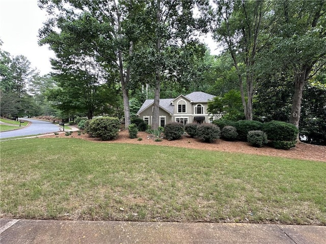 3962 Fox Glen Dr, Woodstock, GA 30189 - view of front facade with a front lawn, stucco siding, and view of scattered trees