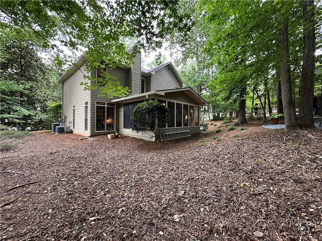3962 Fox Glen Dr, Woodstock, GA 30189 - back of house featuring a sunroom and a chimney