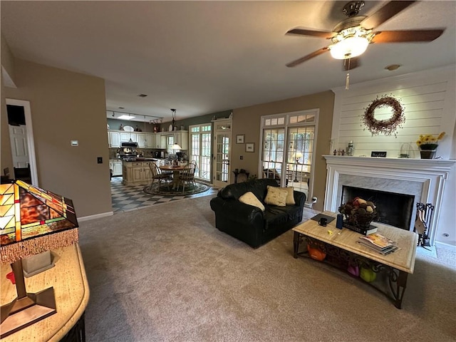 3962 Fox Glen Dr, Woodstock, GA 30189 - living area with dark carpet, ceiling fan, and a fireplace
