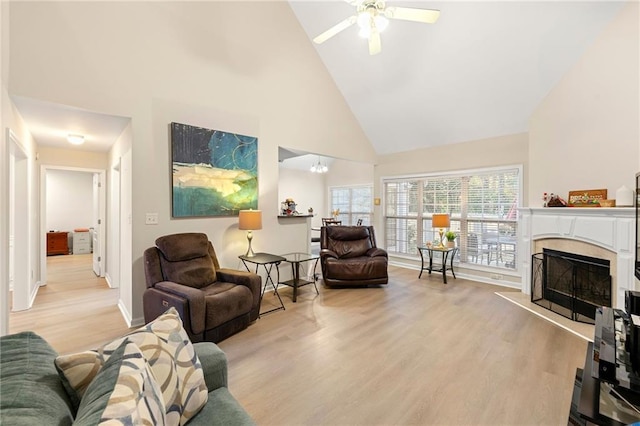 living room with ceiling fan, light hardwood / wood-style floors, and high vaulted ceiling