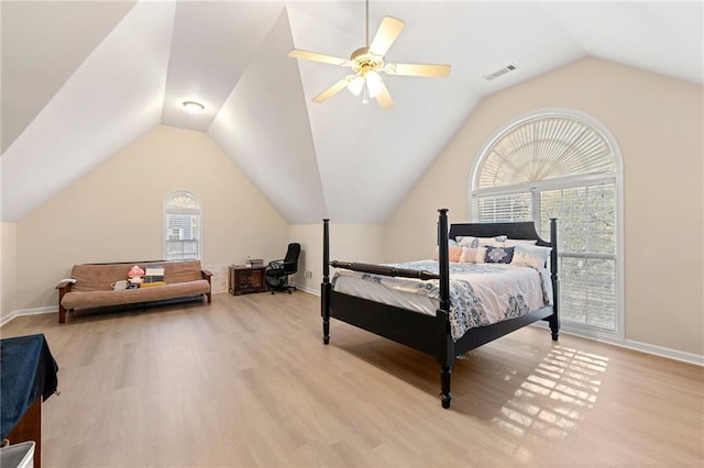 bedroom featuring ceiling fan, light hardwood / wood-style floors, lofted ceiling, and multiple windows