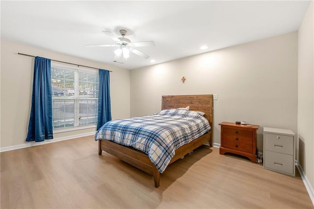 bedroom with light hardwood / wood-style flooring and ceiling fan