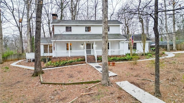 view of front of house featuring a porch and a chimney