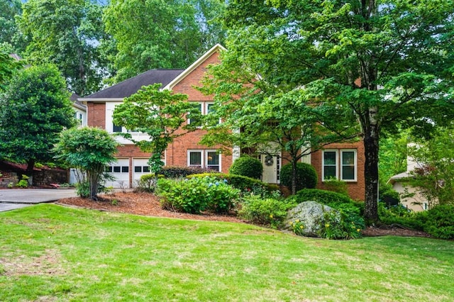 2610 Chadwick Rd, Marietta, GA 30066 - view of front of property with brick siding, a garage, a front yard, and driveway