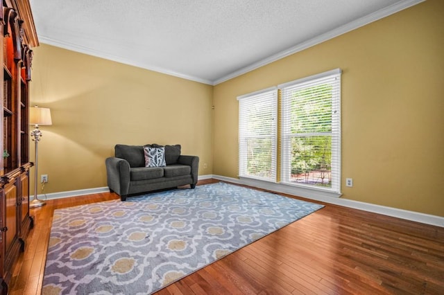 2610 Chadwick Rd, Marietta, GA 30066 - living area with crown molding, hardwood / wood-style flooring, baseboards, and a textured ceiling