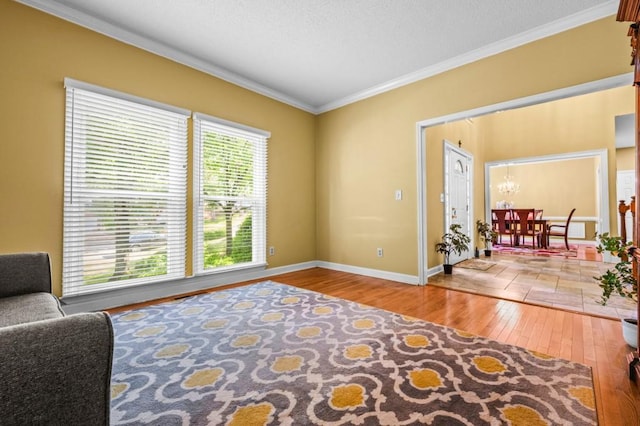2610 Chadwick Rd, Marietta, GA 30066 - living area featuring wood-type flooring, ornamental molding, baseboards, and a chandelier
