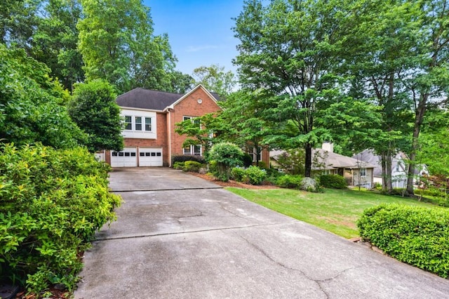 2610 Chadwick Rd, Marietta, GA 30066 - view of front facade featuring a garage, brick siding, concrete driveway, and a front yard