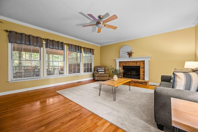 2610 Chadwick Rd, Marietta, GA 30066 - living area with ornamental molding, ceiling fan, wood finished floors, baseboards, and a fireplace