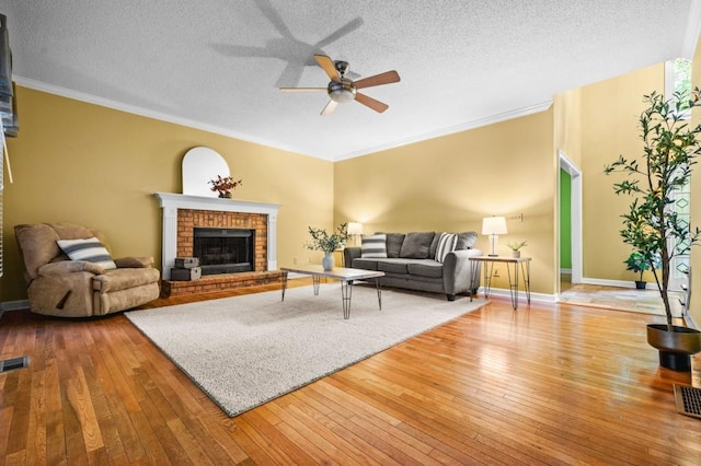 2610 Chadwick Rd, Marietta, GA 30066 - living area with ceiling fan, hardwood / wood-style flooring, baseboards, a fireplace, and crown molding