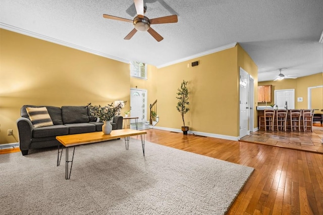 2610 Chadwick Rd, Marietta, GA 30066 - living area featuring a ceiling fan, hardwood / wood-style floors, crown molding, baseboards, and a textured ceiling