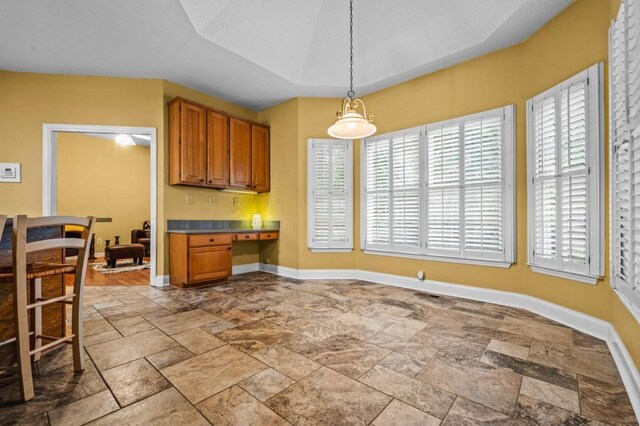 2610 Chadwick Rd, Marietta, GA 30066 - kitchen featuring healthy amount of natural light, stone tile floors, and brown cabinetry