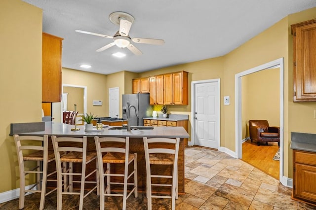 2610 Chadwick Rd, Marietta, GA 30066 - kitchen featuring baseboards, a kitchen breakfast bar, and a sink