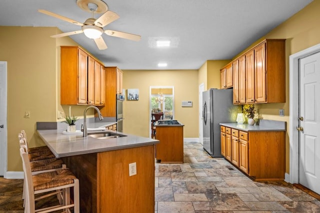 2610 Chadwick Rd, Marietta, GA 30066 - kitchen with stone tile flooring, a peninsula, a sink, a kitchen island, and baseboards