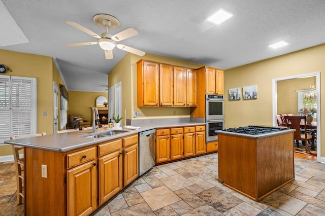 2610 Chadwick Rd, Marietta, GA 30066 - kitchen with appliances with stainless steel finishes, a sink, light countertops, ceiling fan, and stone tile flooring