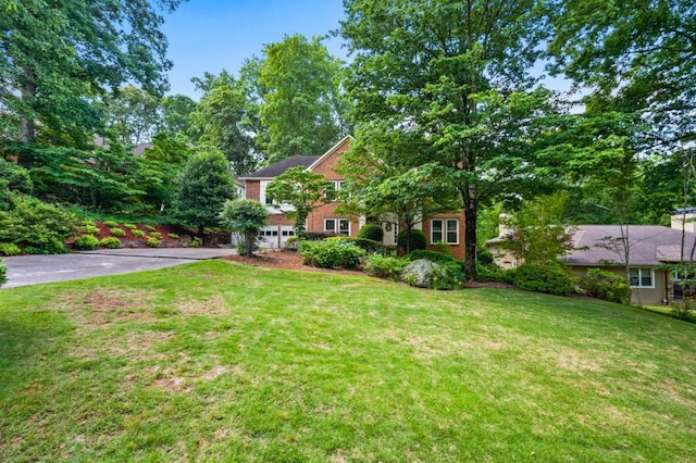 2610 Chadwick Rd, Marietta, GA 30066 - view of front facade with driveway, an attached garage, and a front yard